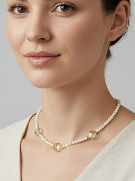 Woman wearing a pearl necklace against a neutral background