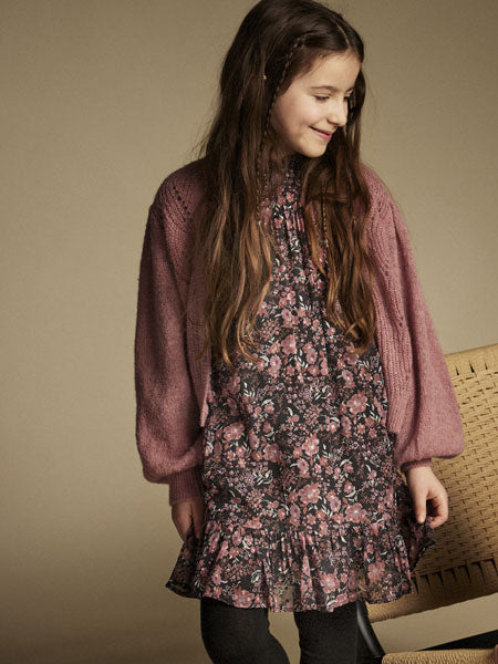 A-line silhouette girls party dress. Black floral print. Small ruffled hem. The brand is Creamie.