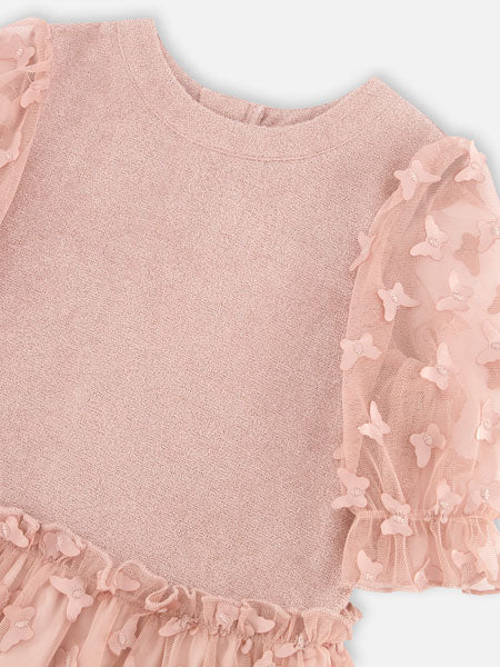 Detail view of rose pink girls party dress by Deux Par Deux. Short sleeve velvet bodice with sheer puffed sleeves, a round neckline, and an elastic waist flared A-line skirt covered in butterfly appliques.