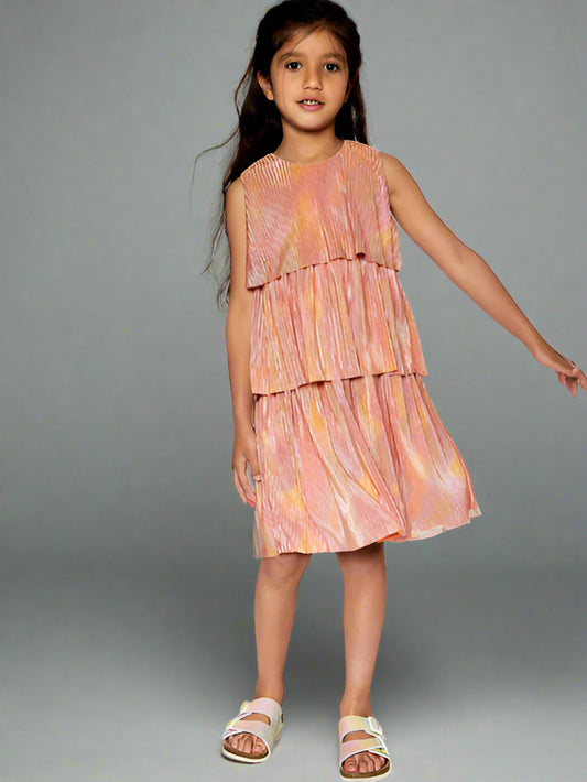 Girl modeling metallic rainbow print, this pleated party dress features a sleeveless bodice with wide straps, a round neckline, and three separate tiers. By Deux Par Deux.