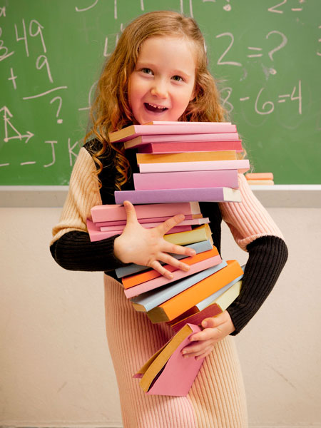 Girl with school books wearing  the color block knitted girls sweater dress in pink, beige and black. Contemporary style by Deux Par Deux.