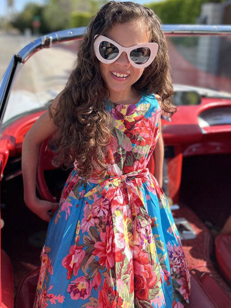 A 50's classic girls summer dress in blue turquoise floral fabric - this dress with petticoats is belted at the waist for a flattering fit.