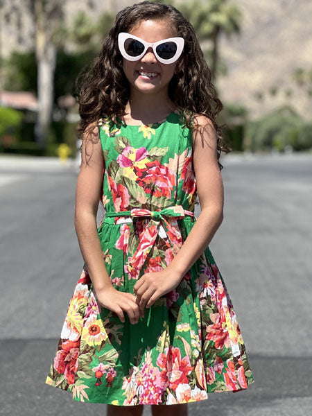 Girls sleeveless dress in a fun green floral print - this dress with petticoats is belted at the waist for a flattering look. Spring and summer party dress.