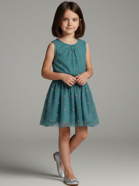 Young girl wearing a teal dress with a subtle pattern on a gray background