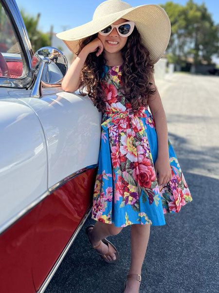 A 50's classic girls summer dress in blue turquoise floral fabric - this dress with petticoats is belted at the waist for a flattering fit.