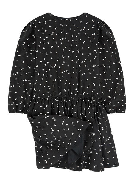 Back view. Black with white print girls dress. Long sleeves. Crew neckline. Front zipper. Faux leather piping at zipper and neckline.