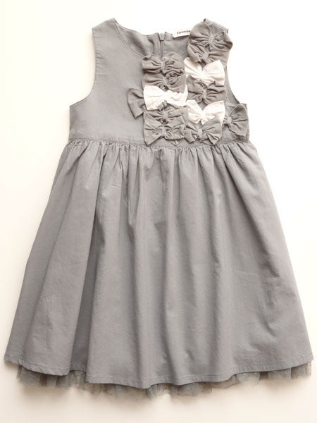 Gray sleeveless little girls party dress by 3 Pommes. High waist, gathered. Small gray and white decorative bows on upper bodice. Gray tulle at skirt hem.