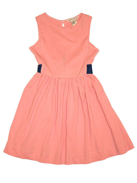 Young girl wearing a pink dress on a gray background