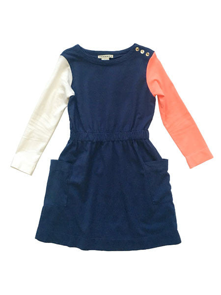 Color block cotton jersey dress. Body is navy with elastic gathered waist. Long sleeves, one white and one coral. Decorative gold buttons on shoulder.