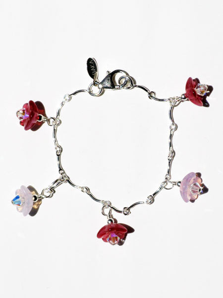 Bracelet with floral charms on a white background