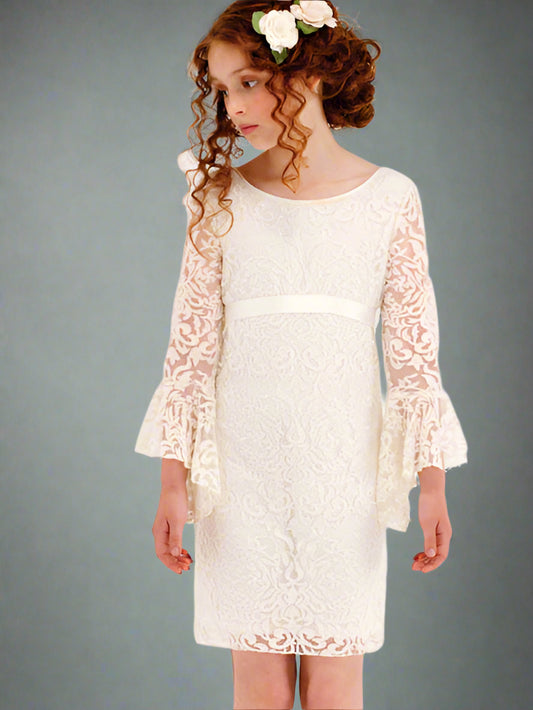 Young girl wearing a white lace dress with bell sleeves against a gray background