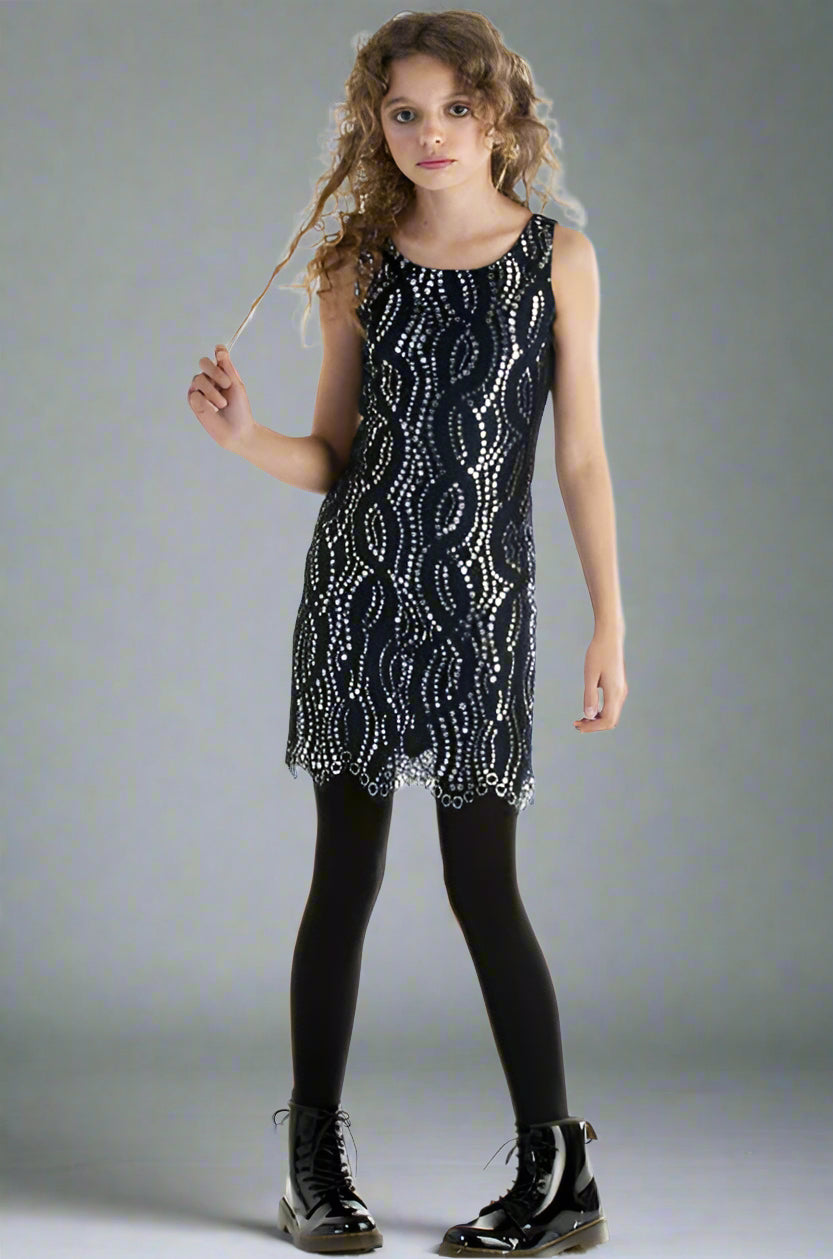 Girl wearing a navy sequin dress against a gray background