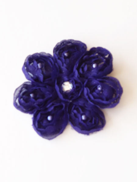 A midnight blue chiffon hair clip with a floral pattern and adorned with crystal beads.