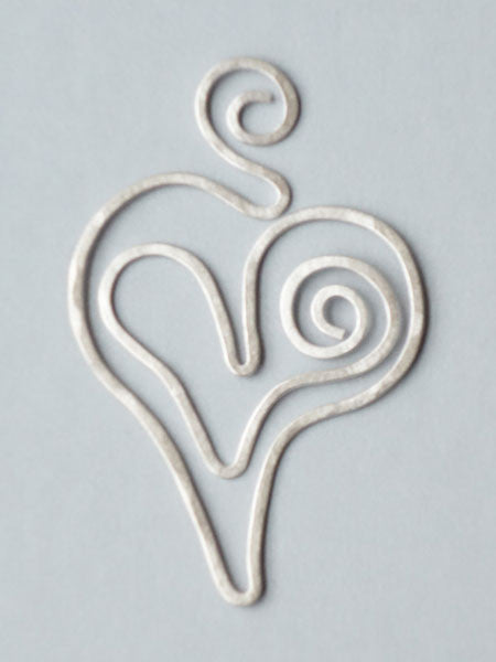 A silver-toned brass bookmark clip in the shape of a heart with a swirl design at the bottom.