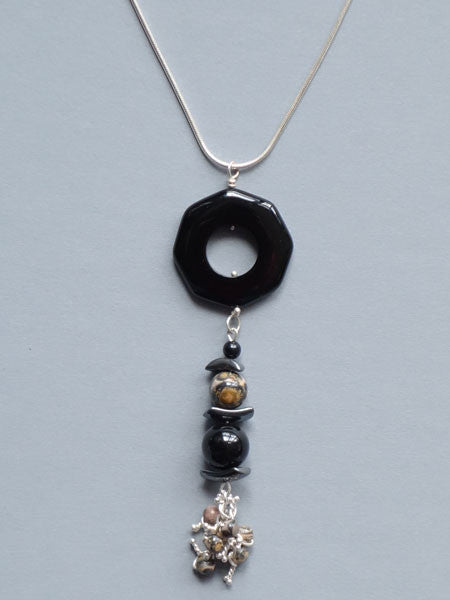 Pendant necklace of black onyx, hematite, and leopard skin jasper beads. Sterling snake chain included.