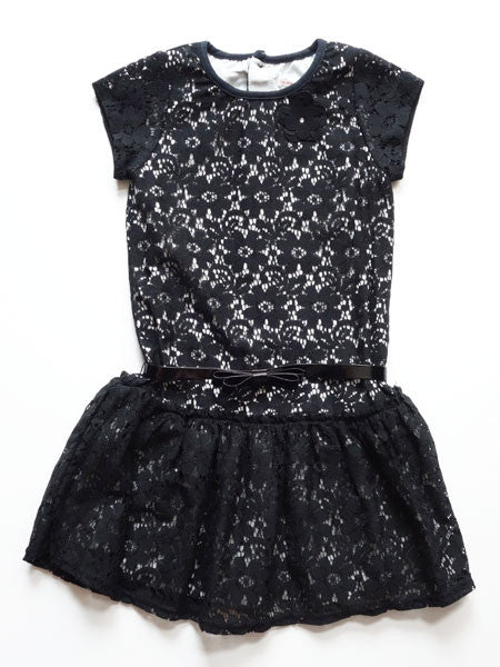 Black lace girls party dress. Drop waist style with patent leather belt at natural waist. Short cap sleeves, white lining visible under lace.