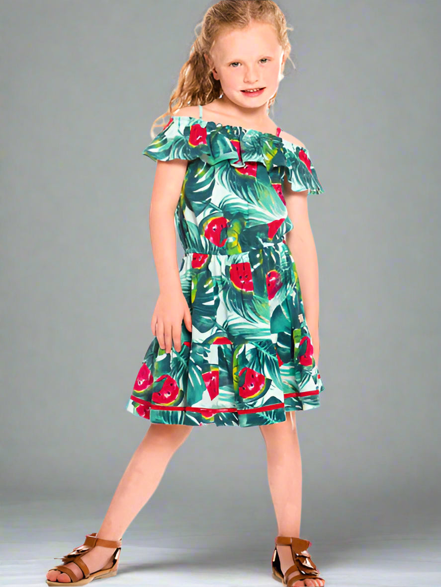 Girl wearing the watermelon print girls sundress by Deux par Deux. Cold shoulder ruffle neckline with thin straps. Gathered waist with full skirt.