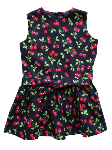Drop waist style sleeveless little girls dress by FiveLoaves TwoFish. Red and green cherry print on black. Bow ties at drop waist, gathered skirt.