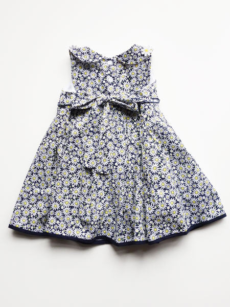 Back of  a daisy print, navy and white, sleeveless dress. Daisy appliques on collar. 