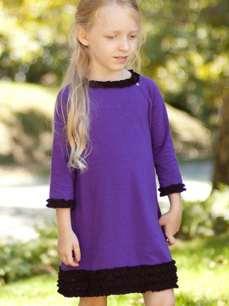 Purple medium weight jersey knit dress, long sleeves. Black ruffle trim on collar, sleeves, and hem line.