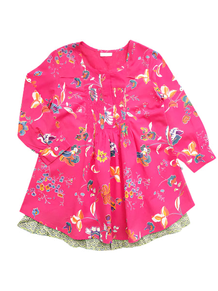 A Dorset pink cotton dress for toddlers with a floral print, featuring a ruffle hem and three button closure at the back.