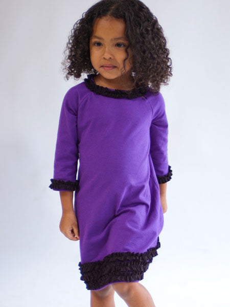 Purple medium weight jersey knit dress, long sleeves. Black ruffle trim on collar, sleeves, and hem line.