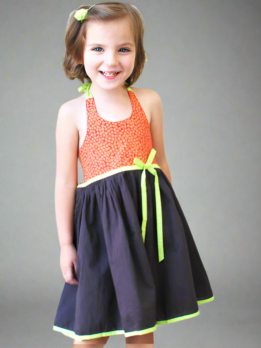 Girl modeling sundress. Poppy orage print halter top with flared charcoal moka brown skirt. Lemon trimming and bow at high waist