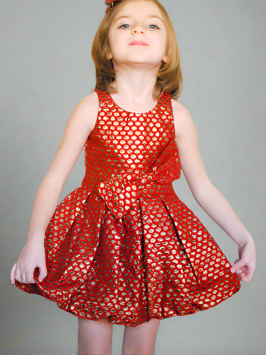Girl modeling metallic gold with red party or holiday dress. Sleeveless with bubble hem and waist sash with bow.