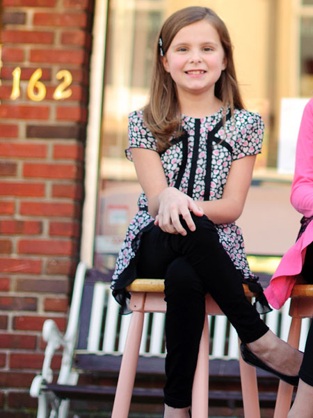 Heart print chiffon girls tunic dress. Pink and white hearts on sheer black fabric with white lining. Black accent fabric.