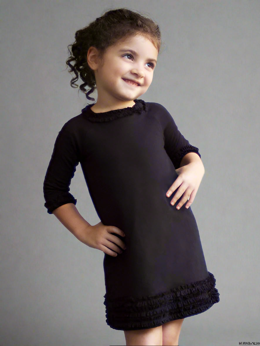 Black medium weight jersey knit dress, long sleeves. Ruffle trim on collar, sleeves, and hem line.
