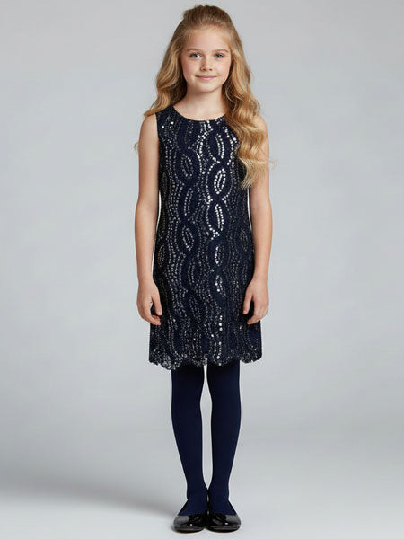 Young girl wearing a navy sequin dress on a plain background