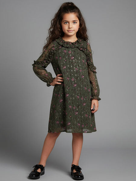 Young girl wearing a green floral dress against a gray background