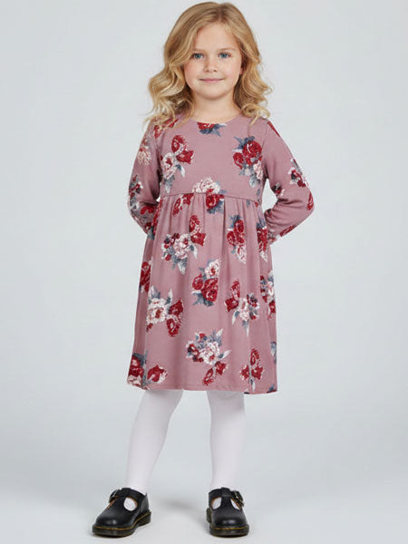 Young girl wearing a pink floral dress on a white background