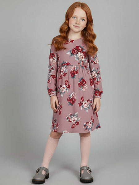 Young girl wearing a floral dress on a gray background