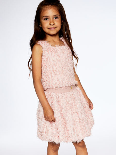 Girl modeling a pretty pink two piece set features a sleeveless top with wide straps, a square neckline, and a matching bubble skirt with a stretch elastic waistband. By Deux Par Deux.