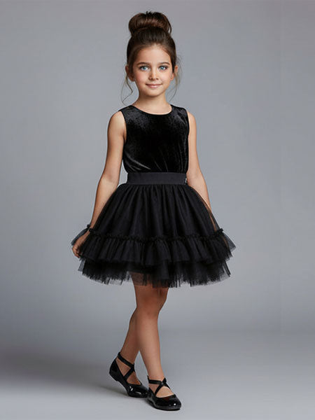 Young girl wearing a black dress with a gray background