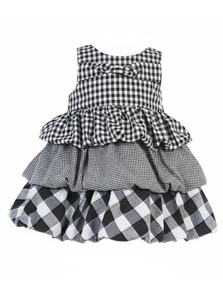 Black and white checkered dress with ruffled layers on a white background