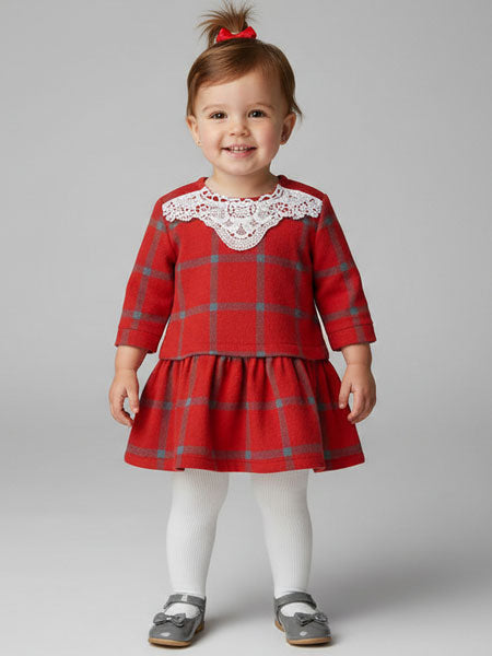 Child wearing a red plaid dress with lace collar on a gray background