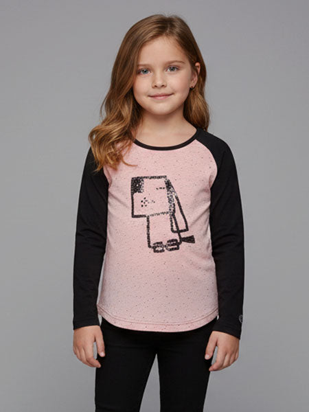 Young girl wearing a pink and black long-sleeve shirt with a graphic design on a gray background