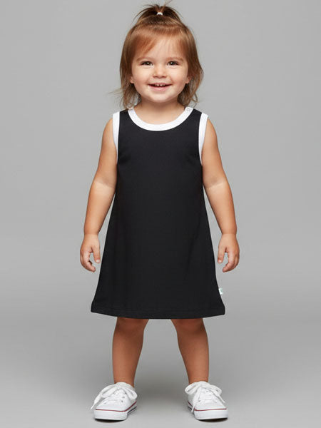 Child wearing a black dress with white trim on a gray background