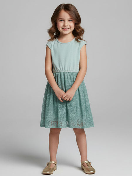 Young girl wearing a light green dress on a plain background