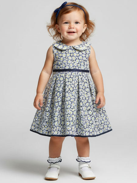 Child wearing a floral dress with a plain background