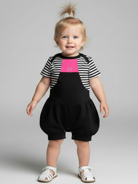 Child wearing a black and white striped shirt with a pink center and black bubble romper on a gray background