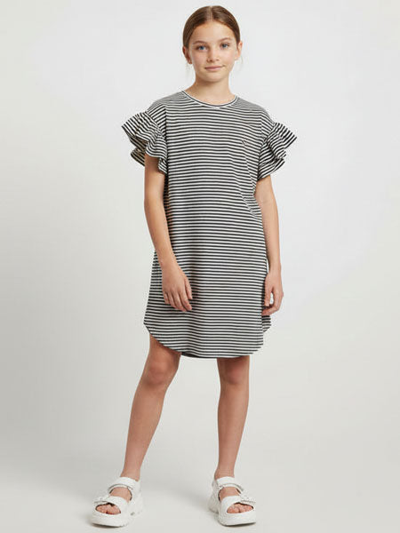 Young girl wearing a black and white striped dress with ruffled sleeves on a white background