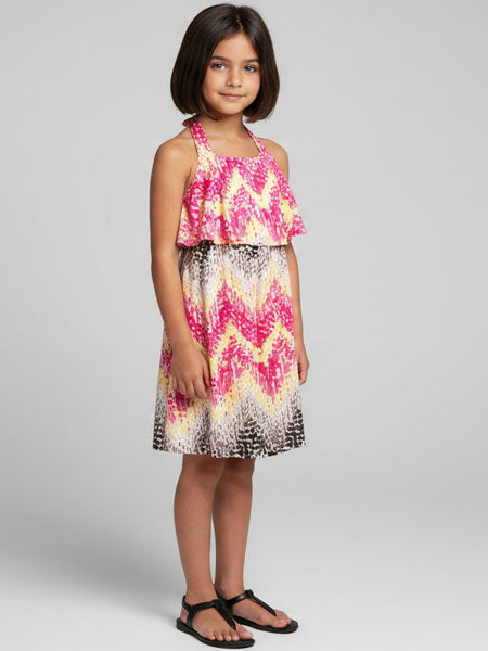 Young girl wearing a colorful dress with a white background