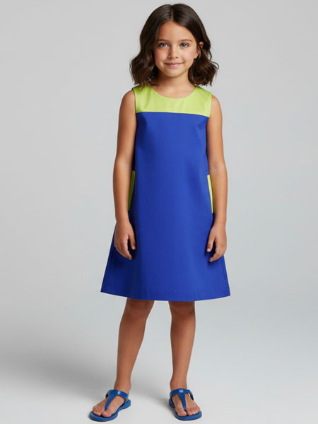 Young girl wearing a blue and green dress on a gray background