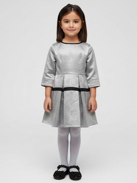 Young girl wearing a gray dress with a plain background