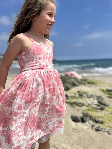 Sleeveless, thin straps, girls party dress in a pink roses print by Vignette. Soft mesh  white tulle at hem.