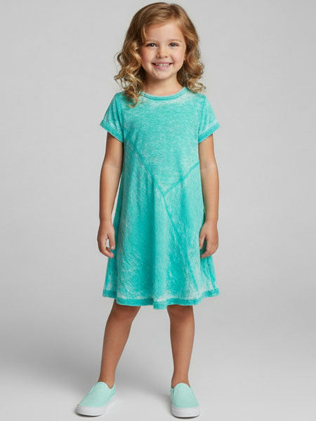 Young girl wearing a teal dress on a plain background