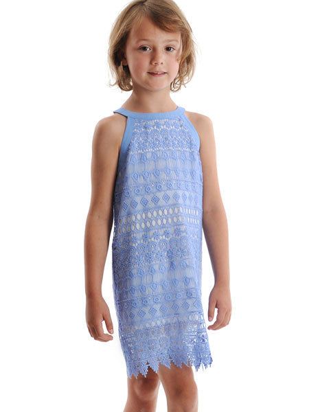 Girl modeling crochet shift style girls party dress by Appaman. HIgh neck, cut away shoulder style. White under layer visible through pretty crochet pattern.